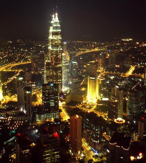 Petronas Towers illuminated at night in Kuala Lumpur